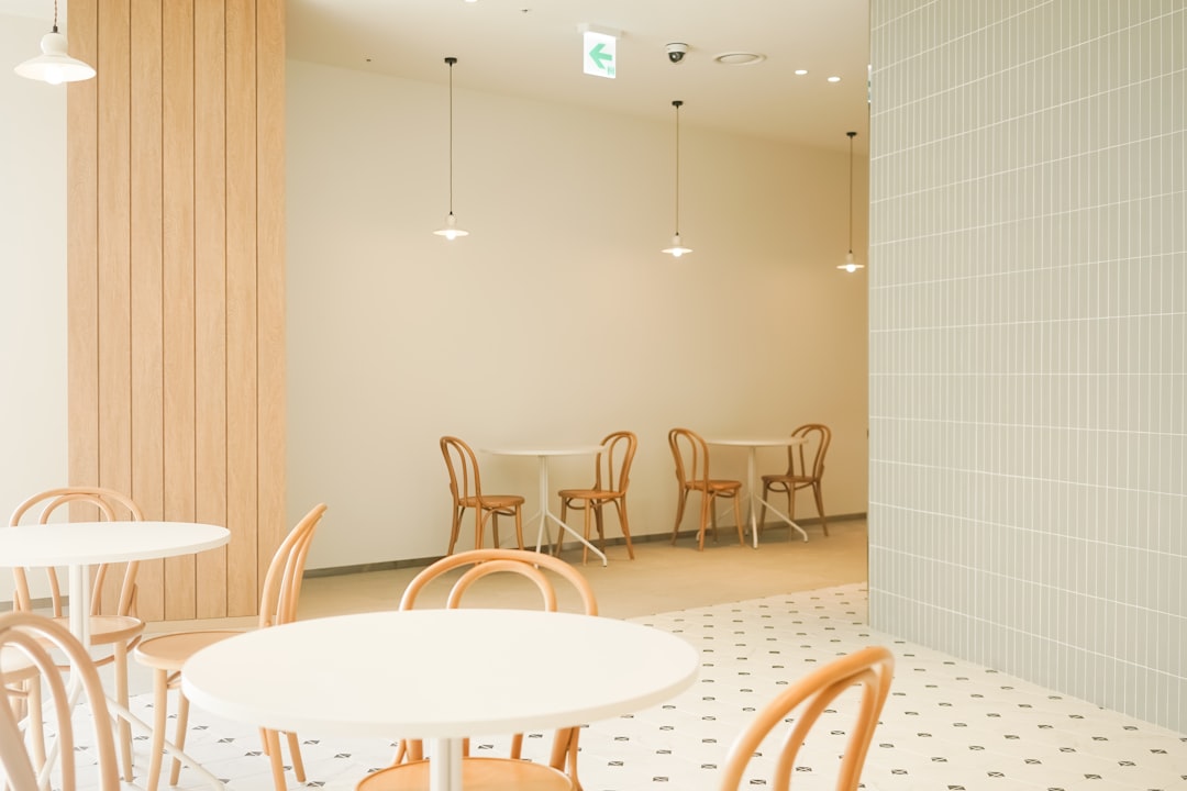 An empty cafe interior with wooden tables and chairs, the bare structural surface a cold-start business has before any review or third-party trail has accumulated