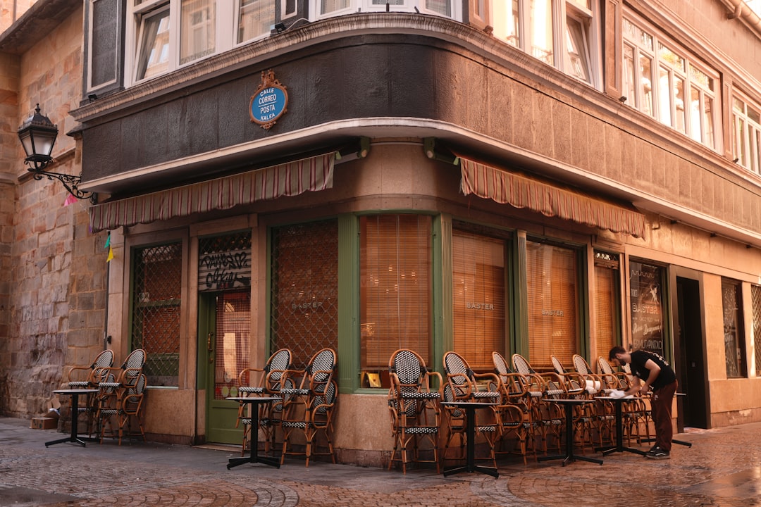 Outdoor cafe seating in front of a historic building — the business whose most-asked fact is whether it is open right now
