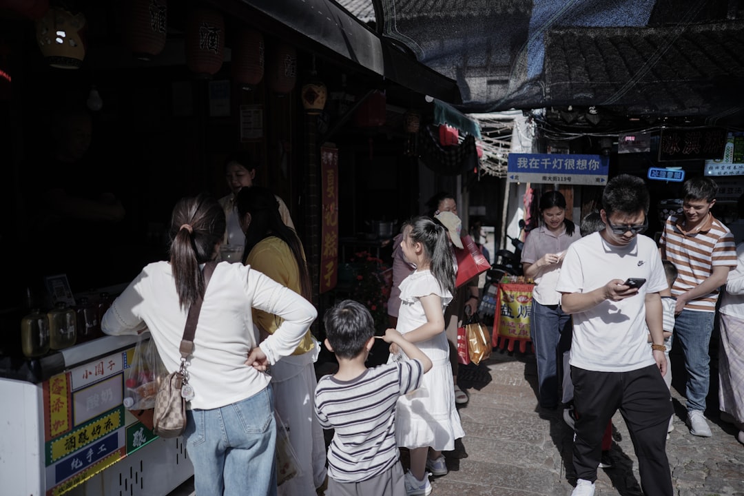 People walking through a bustling market street, the moment a time-sensitive 'is it open?' question gets asked