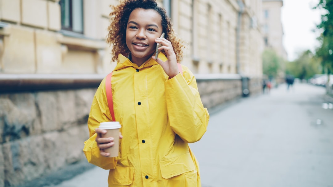 A person on the phone with a coffee: the query moment, where reconciliation happens before any answer is spoken