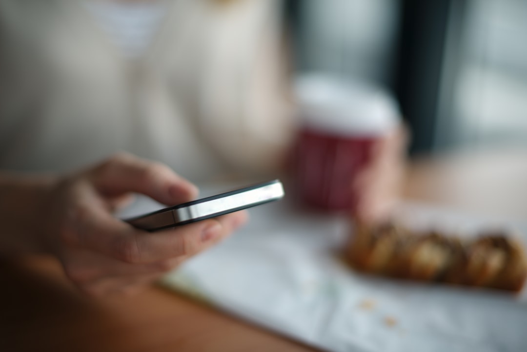 A customer holding a smartphone, the surface where an AI recommendation is rendered
