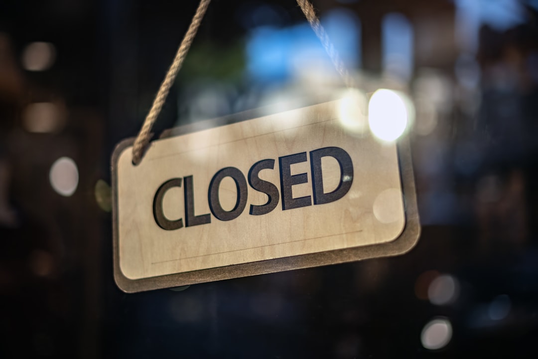 A closed sign hanging in a glass door — the state field that flips while the address never does
