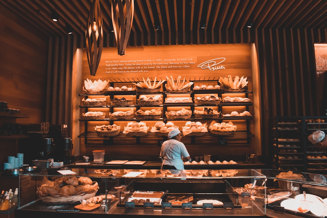 A person working at a wooden shelf — the human reader the prose is written for, beside the machine the JSON-LD is written for
