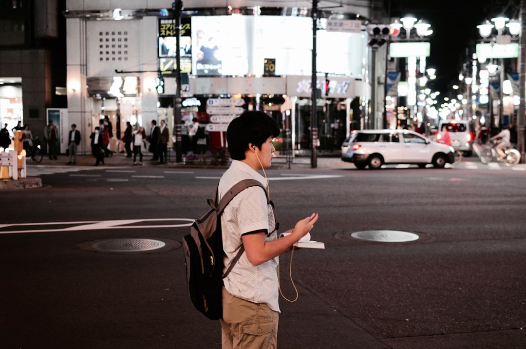 A person on the street, smartphone in hand: the surface where a local AI recommendation actually lands